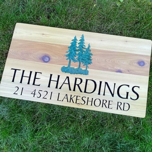 Custom CNC carved solid wood address sign made from premium cedar. Features intricate, precise carving for a durable, natural, and personalized home or business address display. Ideal for outdoor use, showcasing the beauty and resilience of cedar wood.